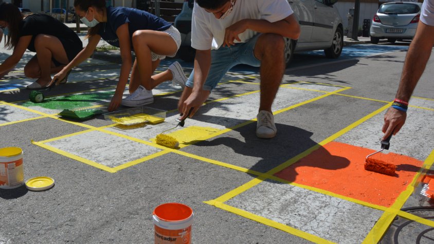 Els joves pìnten la bandera de l'orgull LGBTI en un pas de vianants